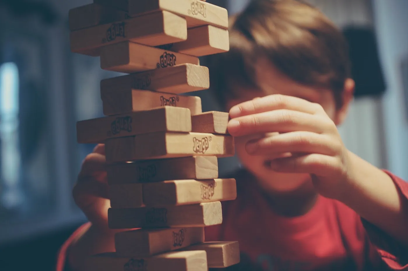 A kid playing Jenga as an analogy to the senior software engineer&#x27;s soft skills and being able to take balanced decisions for the business