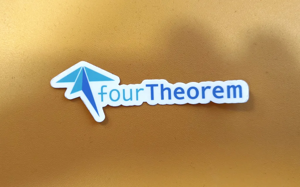 A fourTheorem sticker on a yellow background