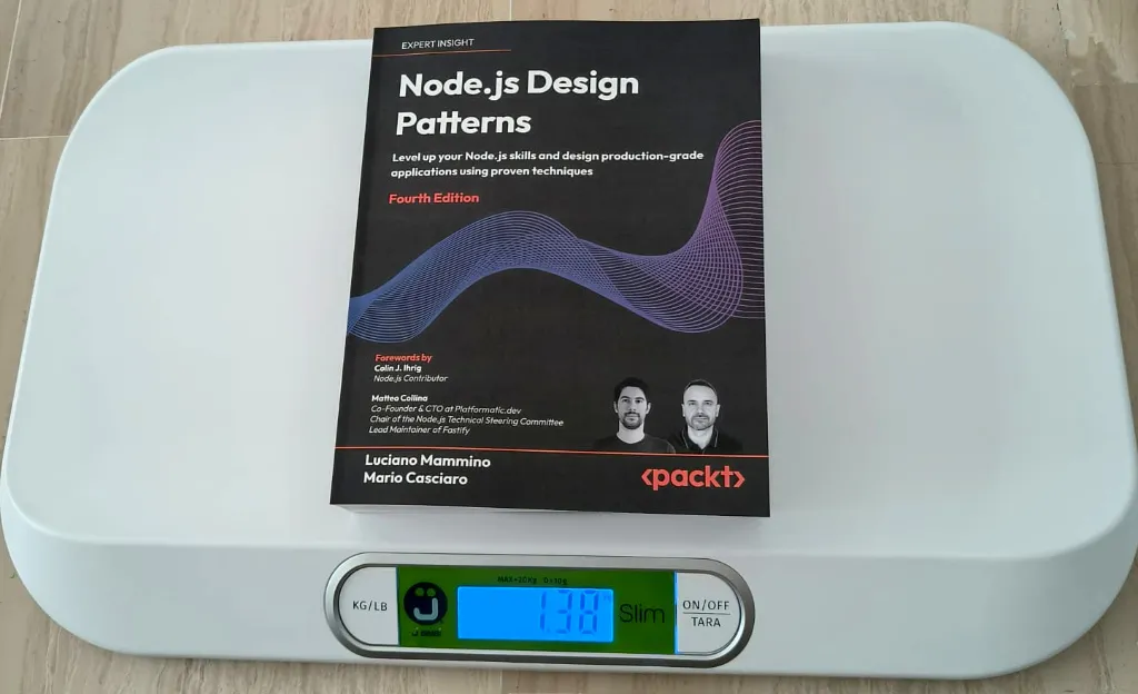 The book ‘Node.js Design Patterns (Fourth Edition)’ lying on a digital kitchen scale showing 1.38 kg
