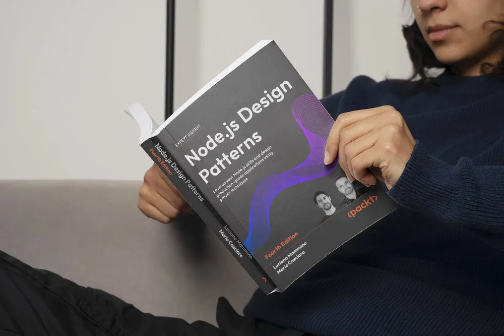 Person reading Node.js Design Patterns (Fourth Edition), with the new edition’s cover clearly visible.